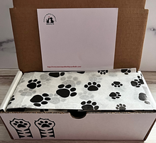 Load image into Gallery viewer, View of box once opened with paw print paper.
